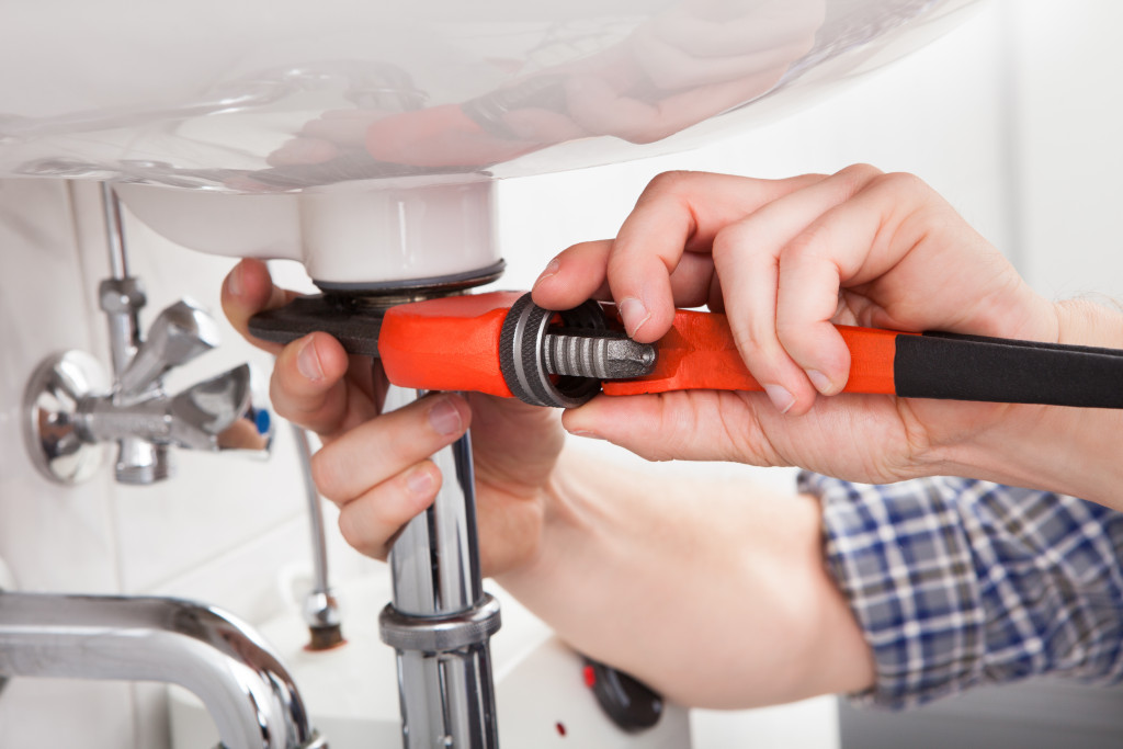 Homeowner attending to plumbing needs