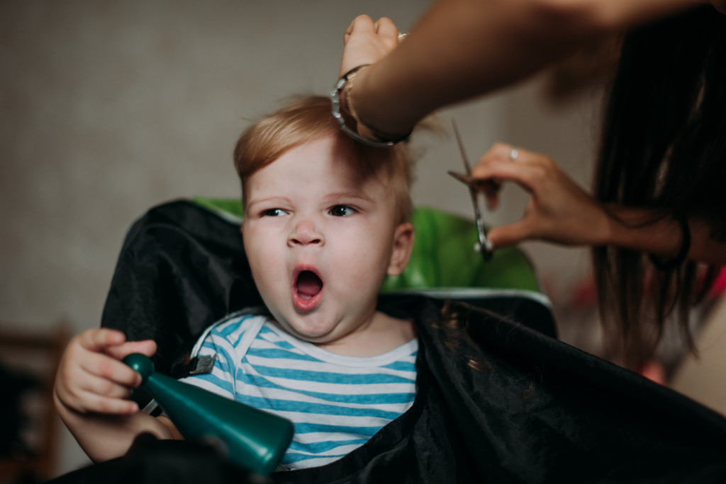 kids hairstyle being done by professional